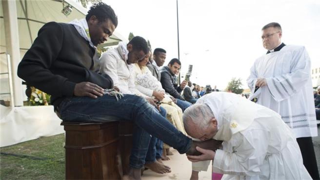 Pope kissing feet